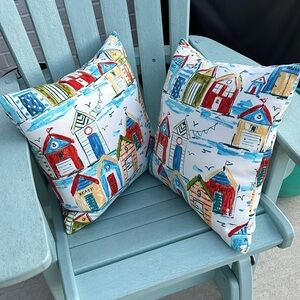 Pair of Coastal Beach Hut Pillows by Solarium. Rows of Beach Huts and Cabanas